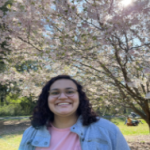 Headshot of Nadine Miller standing outside by a tree